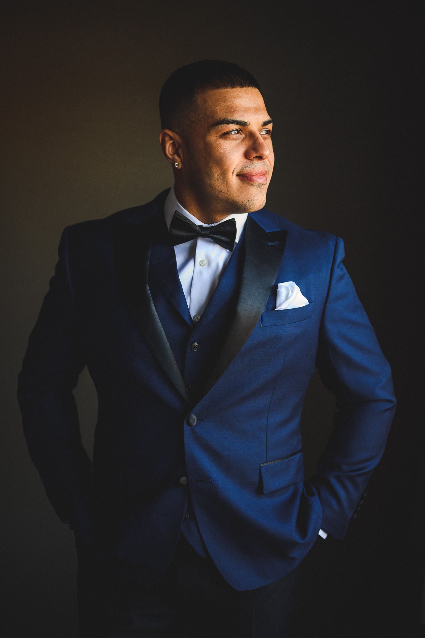 groom portrait near window during groom prep