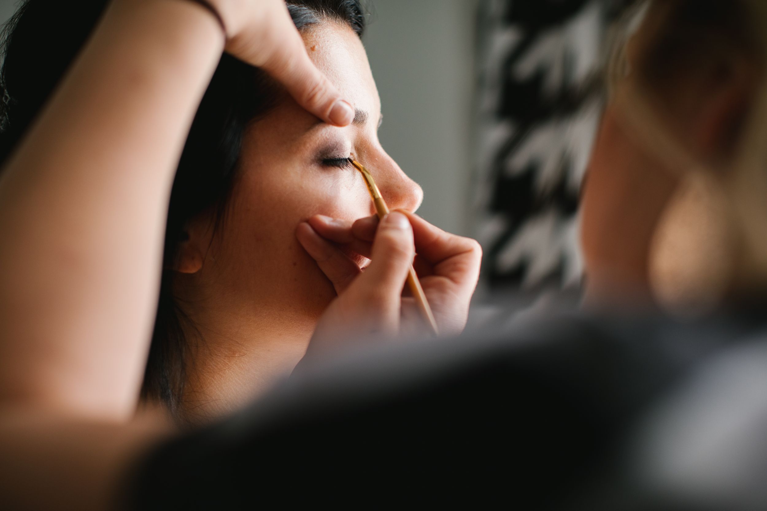 close up of bride getting wedding makeup done
