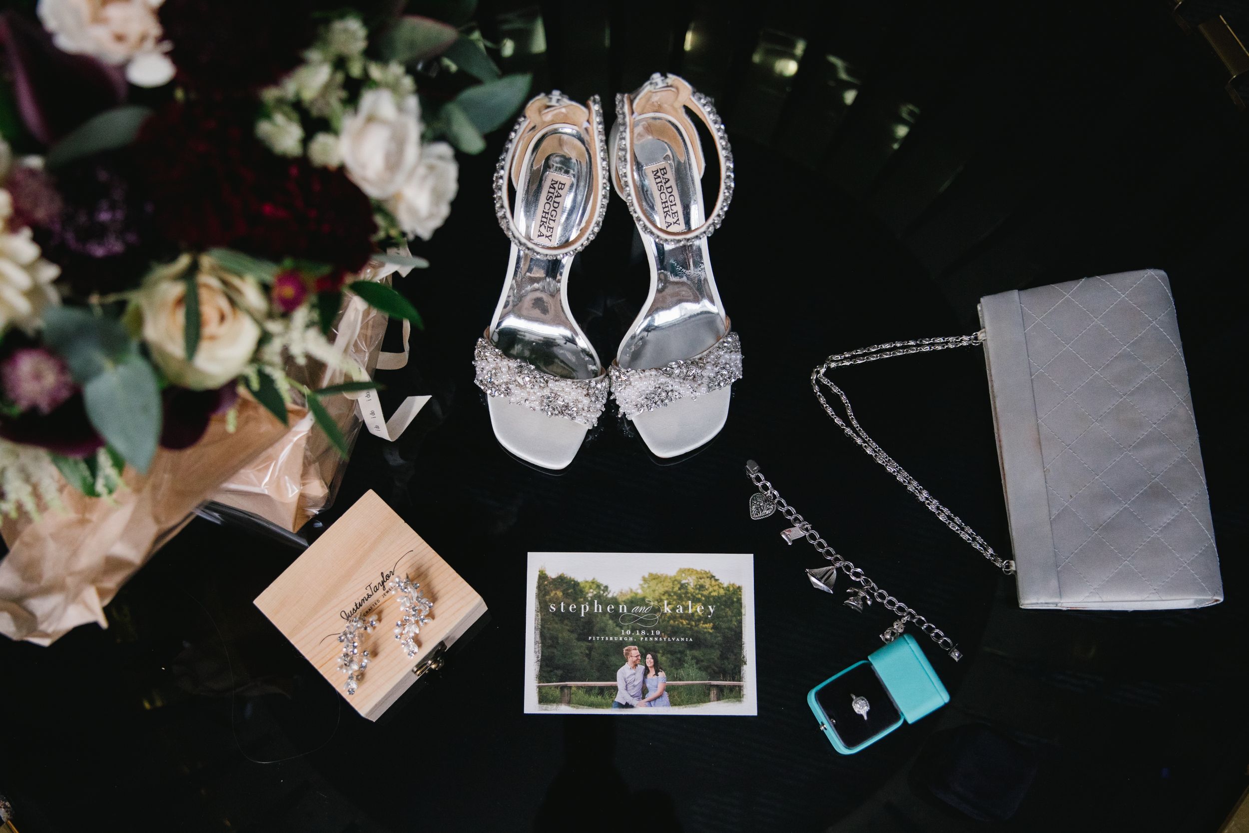 flat lay wedding details on black table top