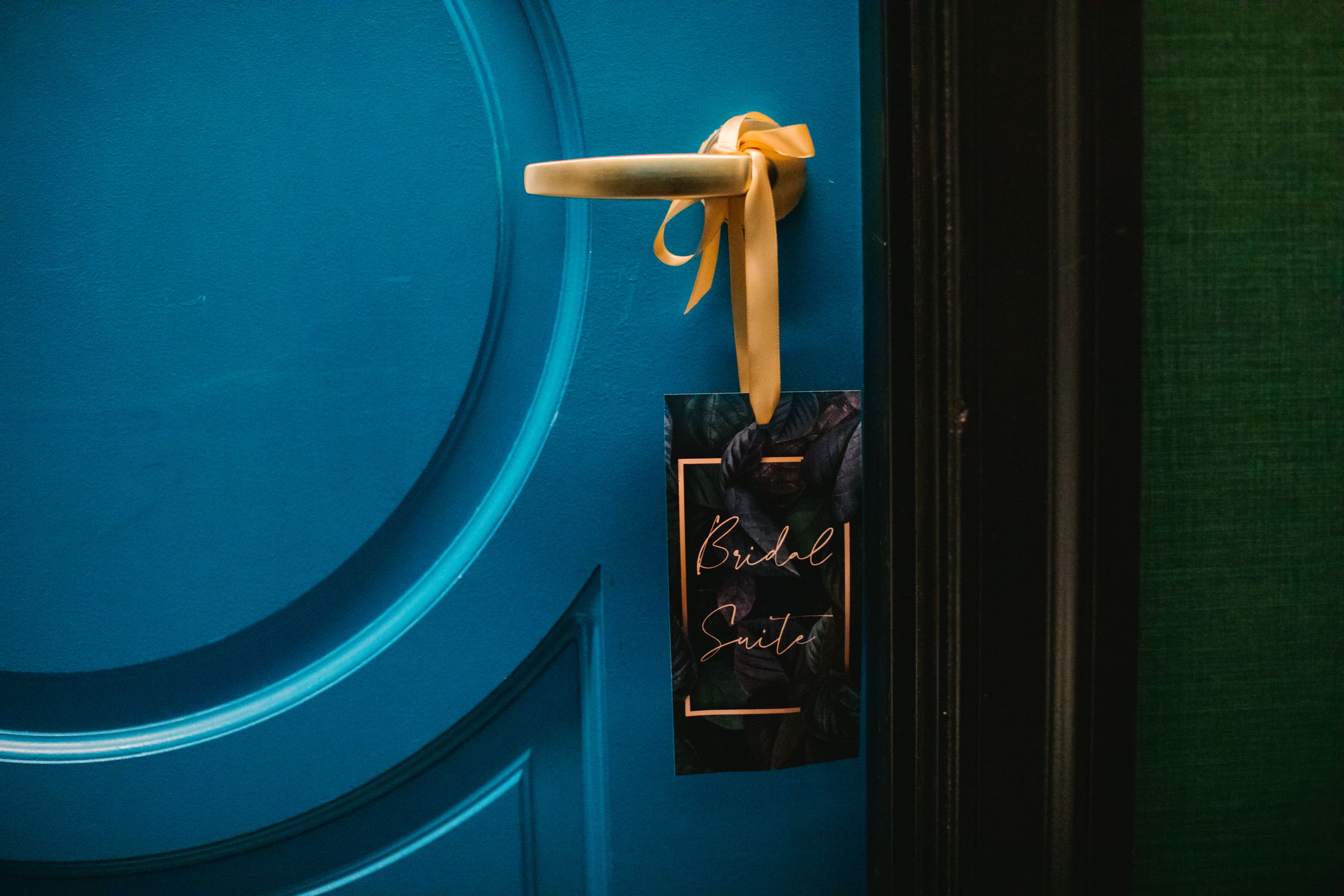 blue door with black bridal suite sign on it
