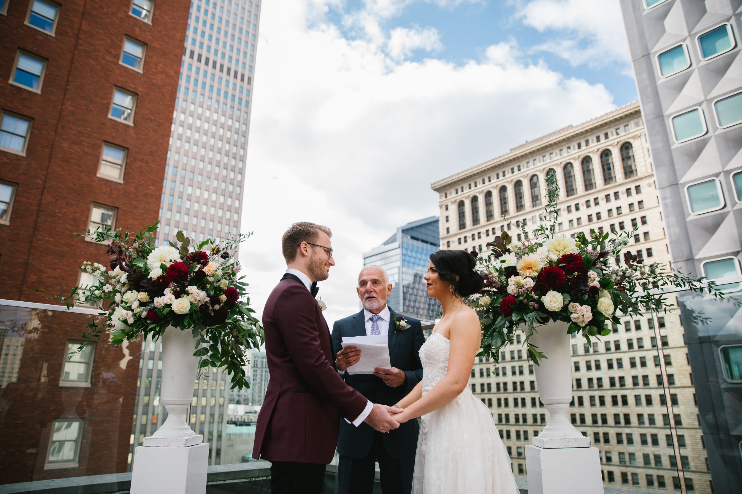 bride and groom holding hands during rooftop wedding ceremony toronto