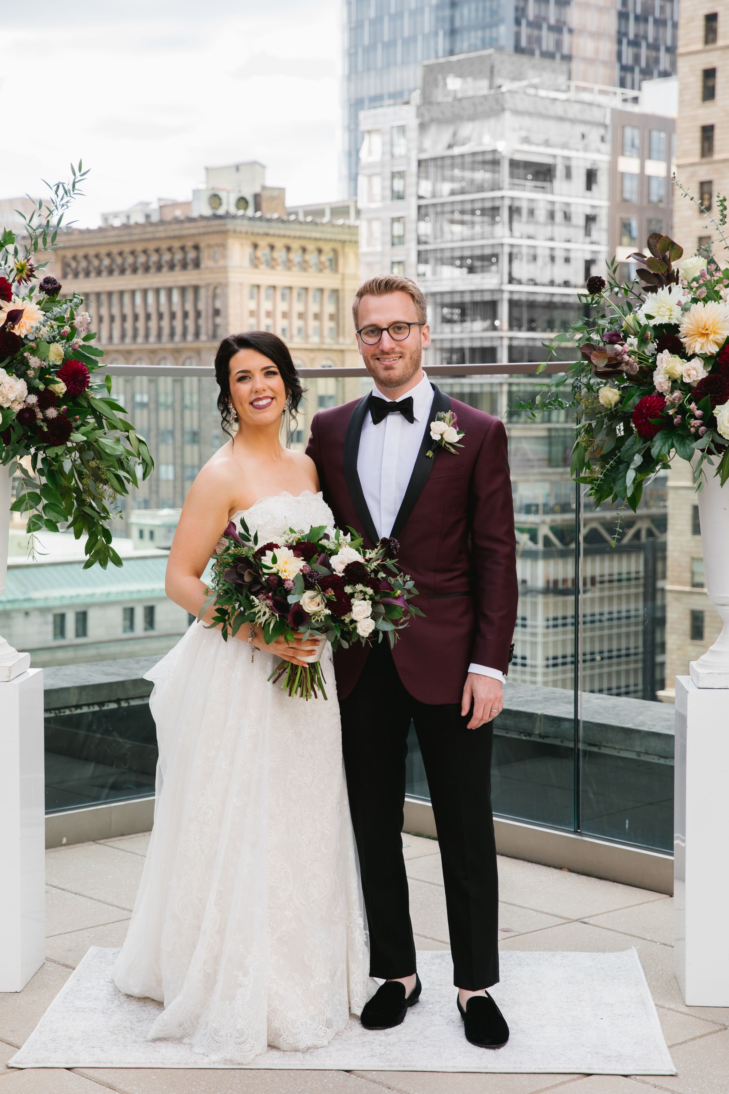 bride and groom portrait rooftop city skyline behind them wedding