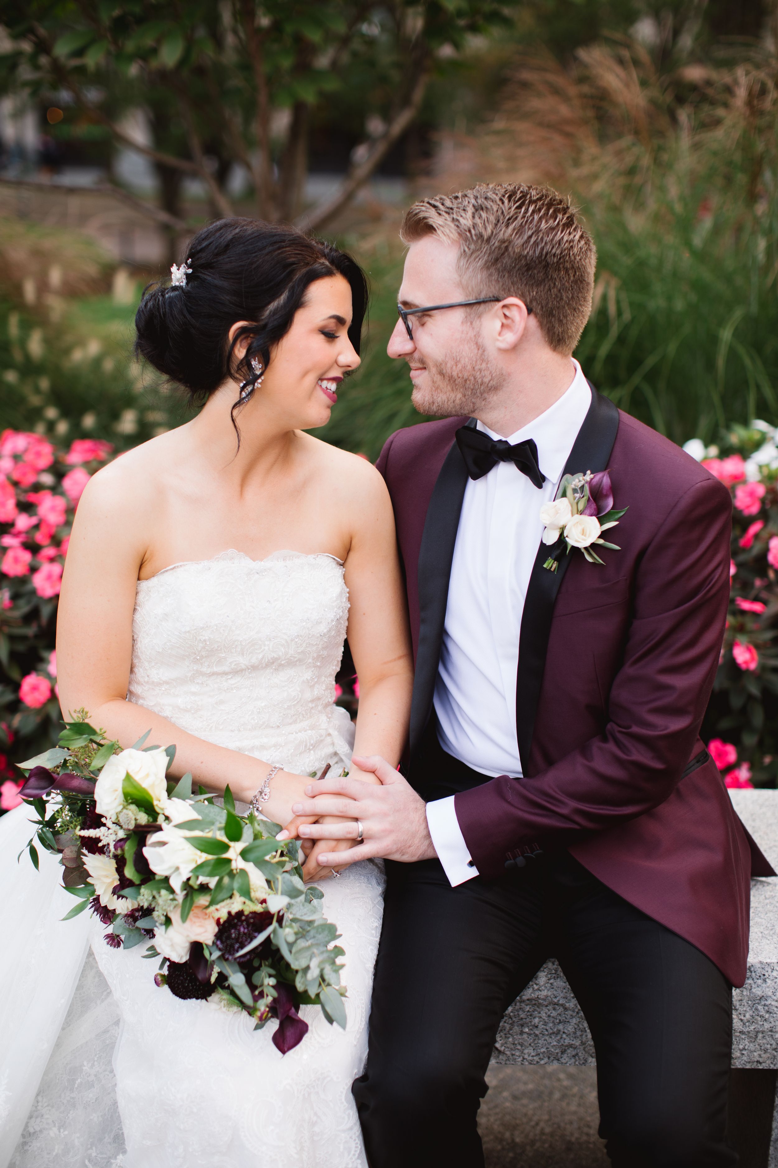bride and groom sitting and looking at each other, smiling