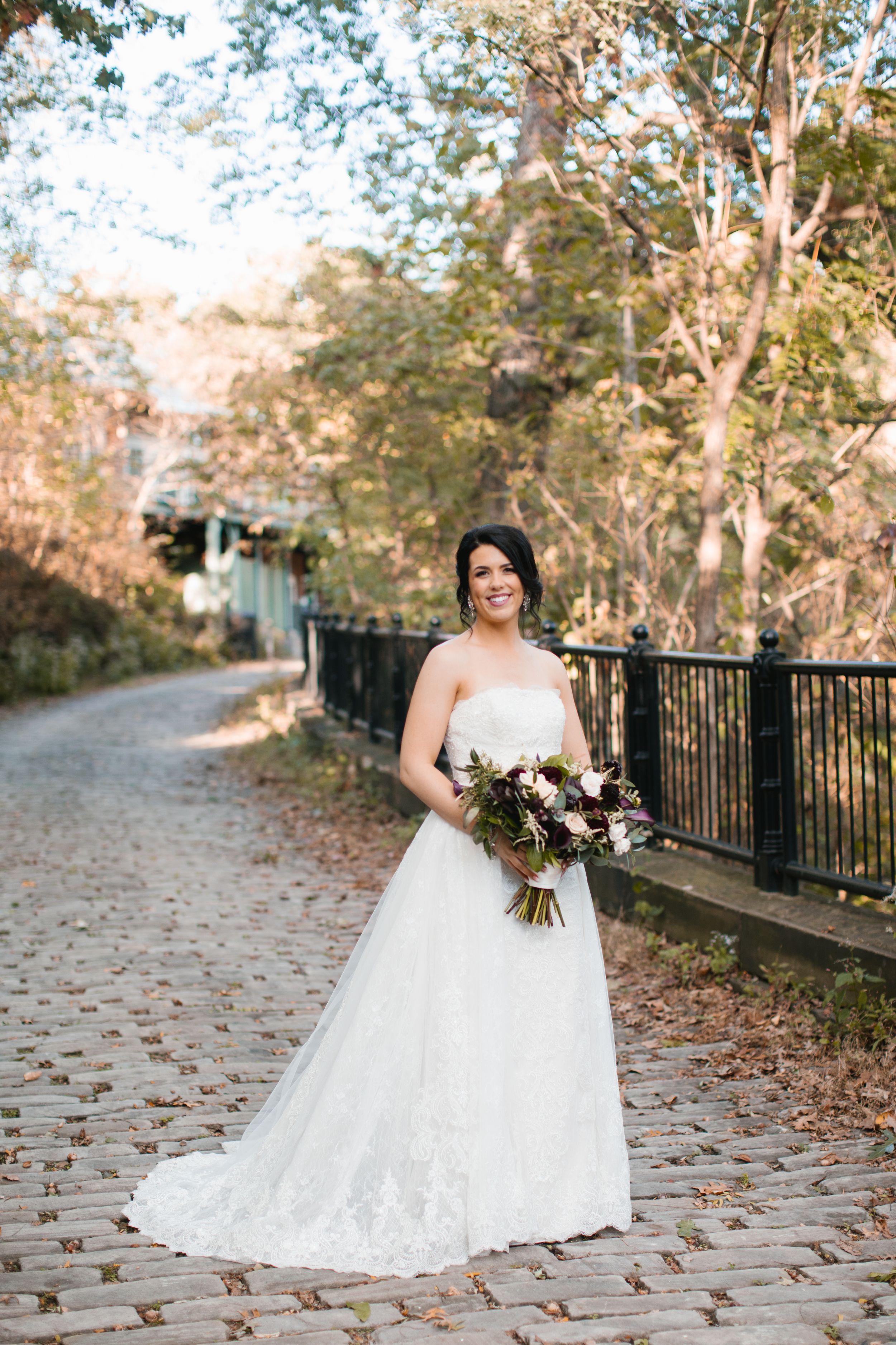 bride portrait on cobblestone pathway in park during fall