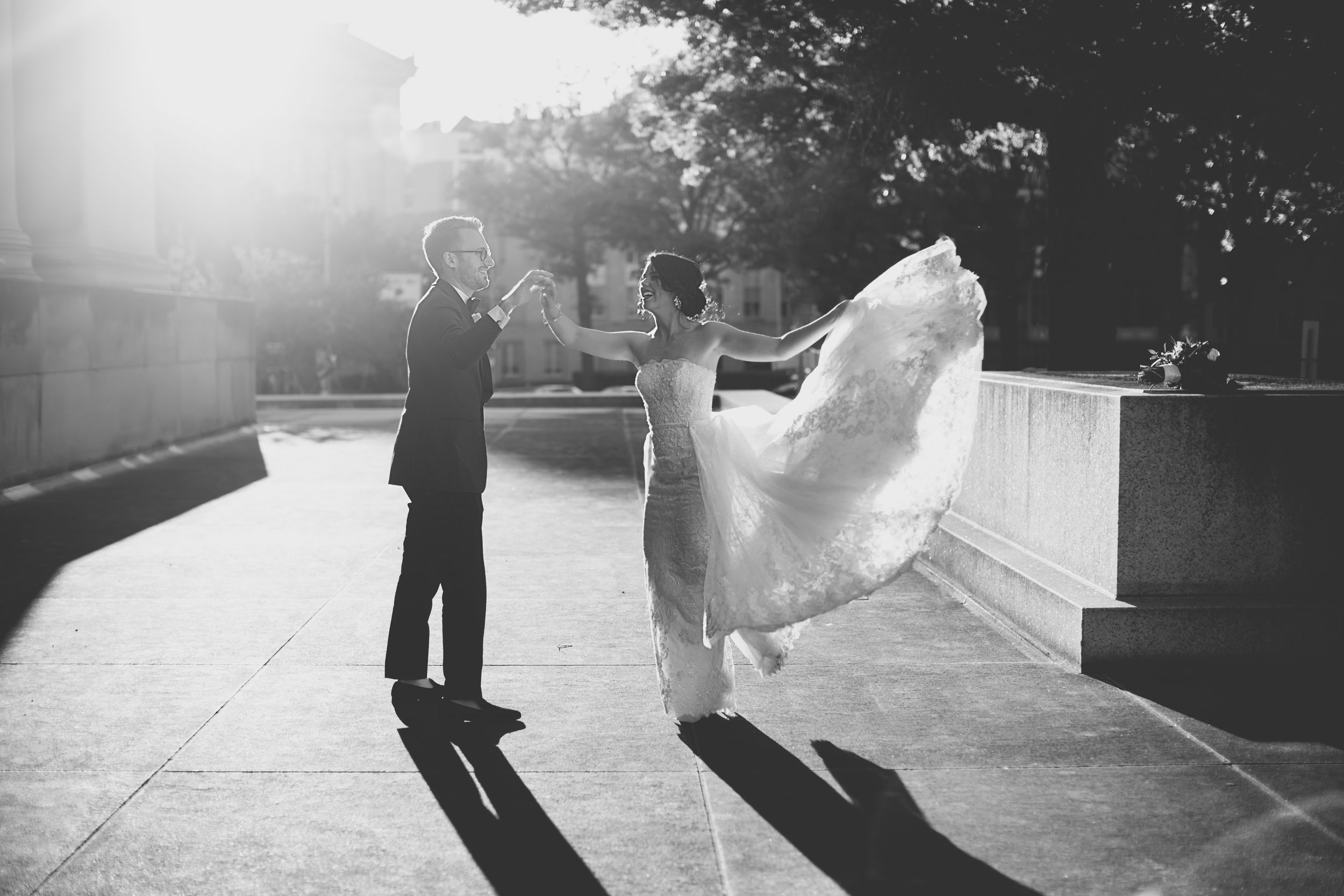 bride and groom black and white photo of him spinning her during sunset wedding toronto