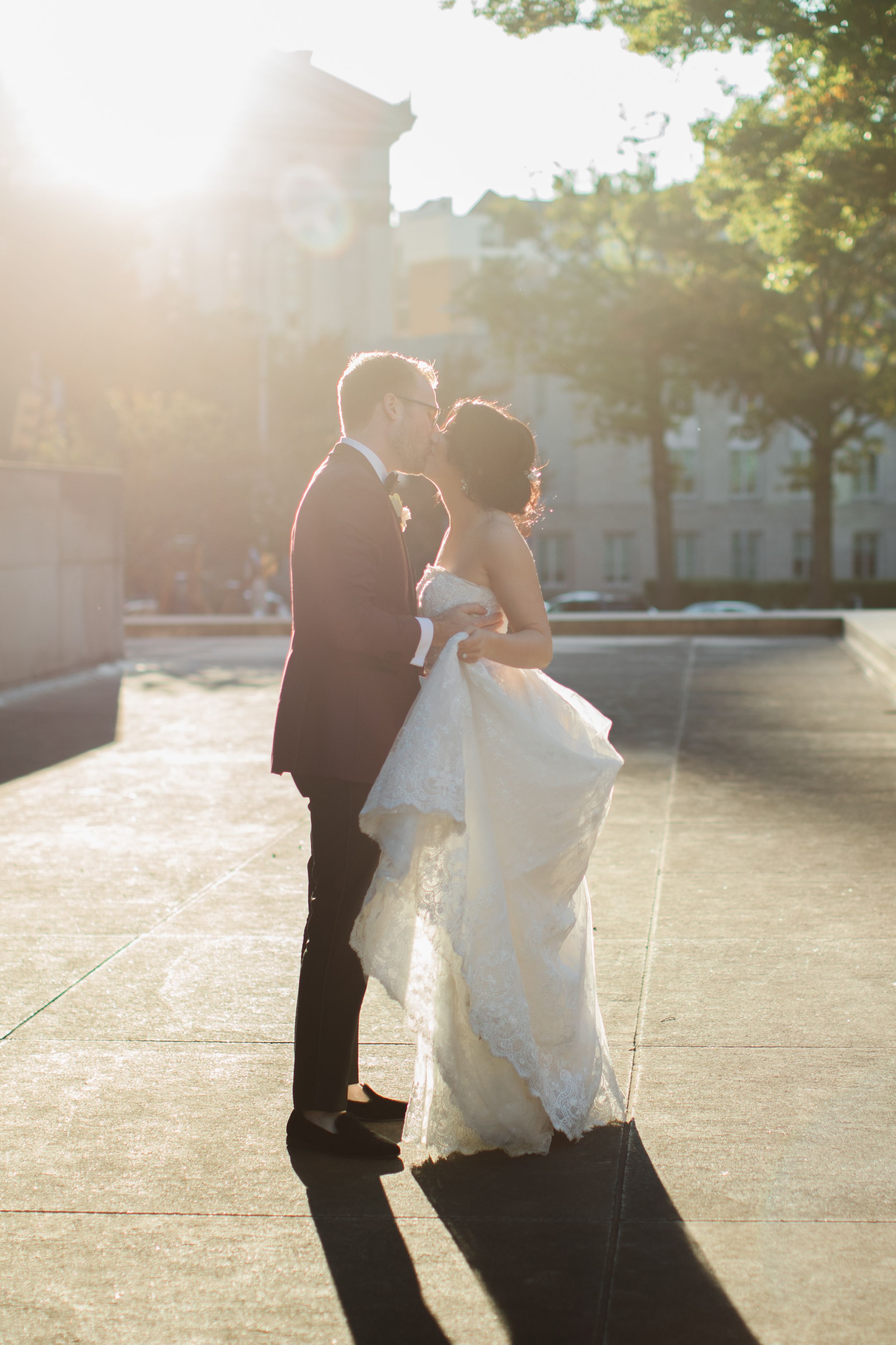 bride and groom kissing in the sun city wedding downtown