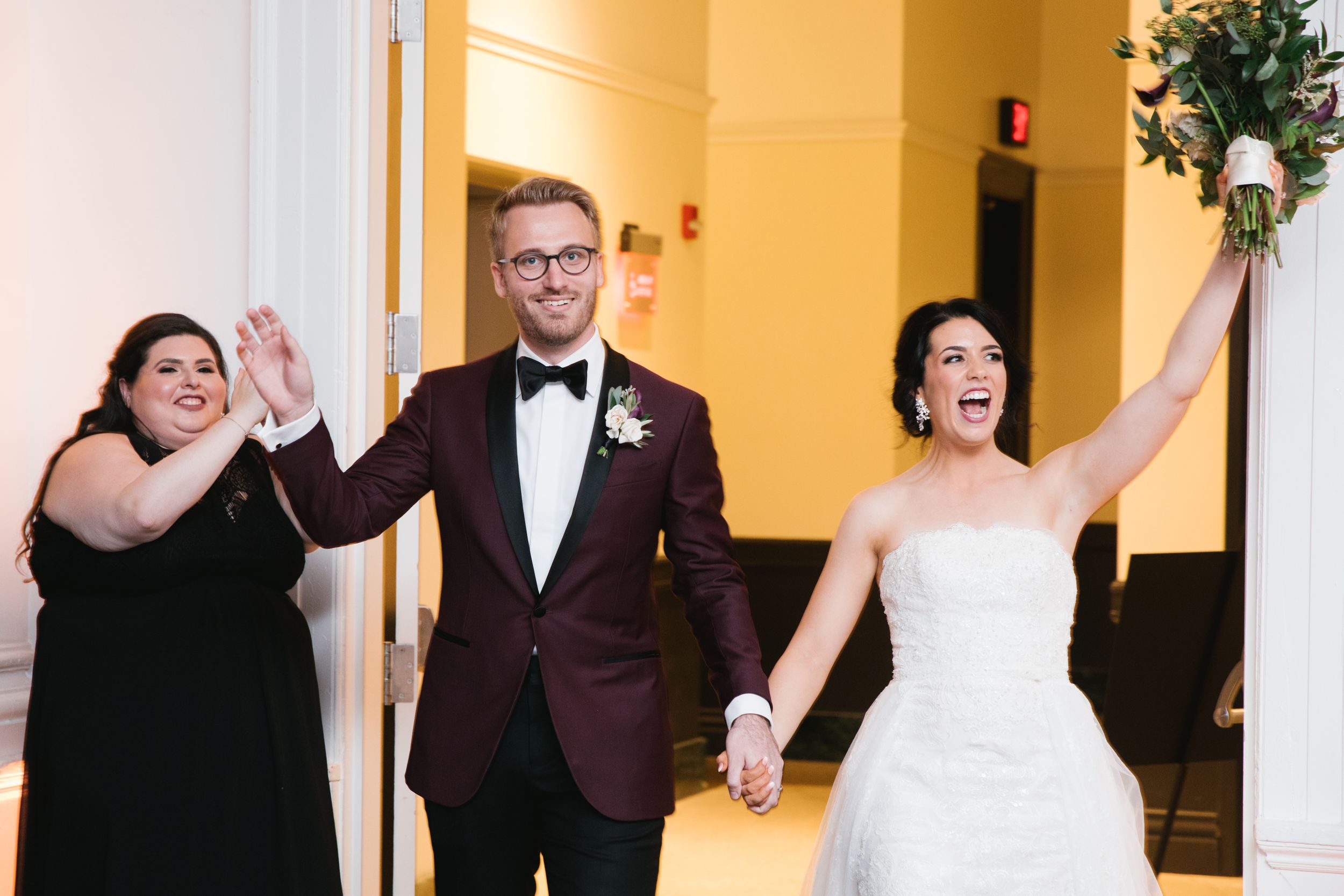 bride and groom enter reception hall with a celebration wedding