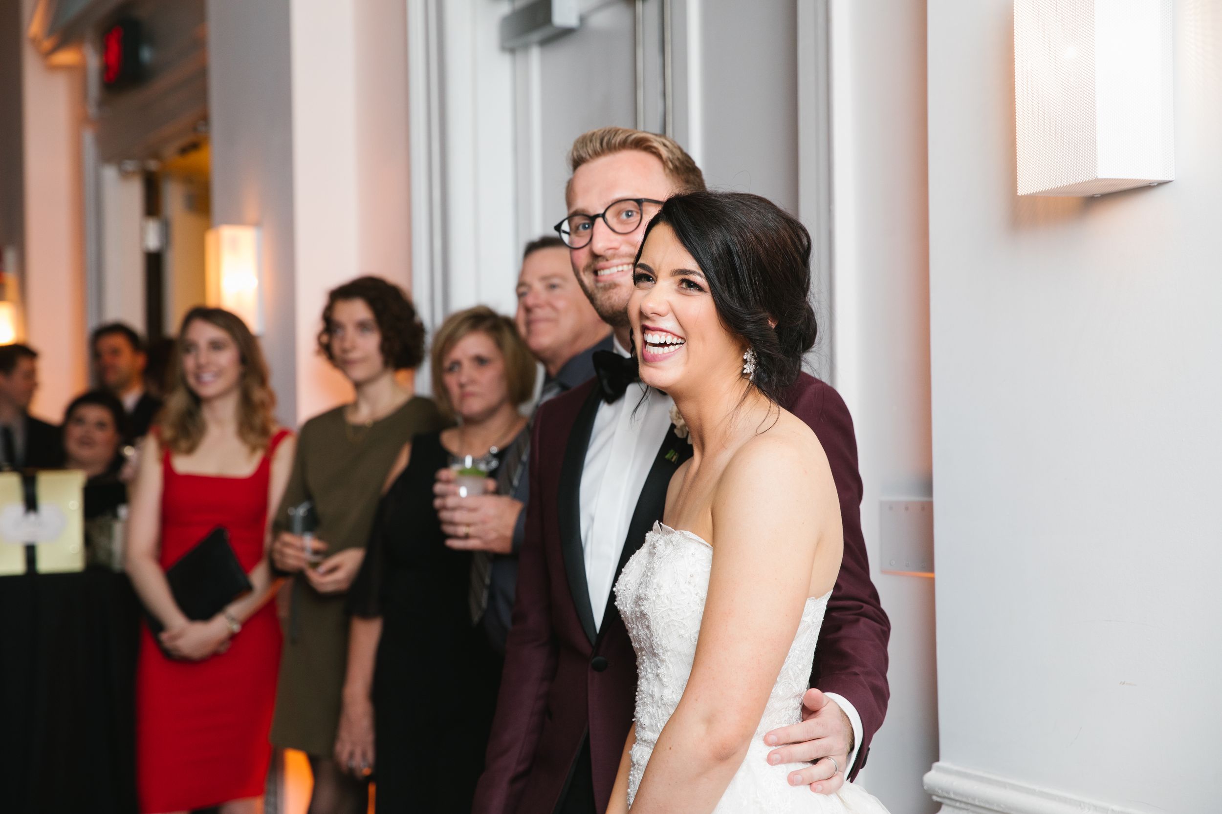 bride laughing while listening to maid of honours speech
