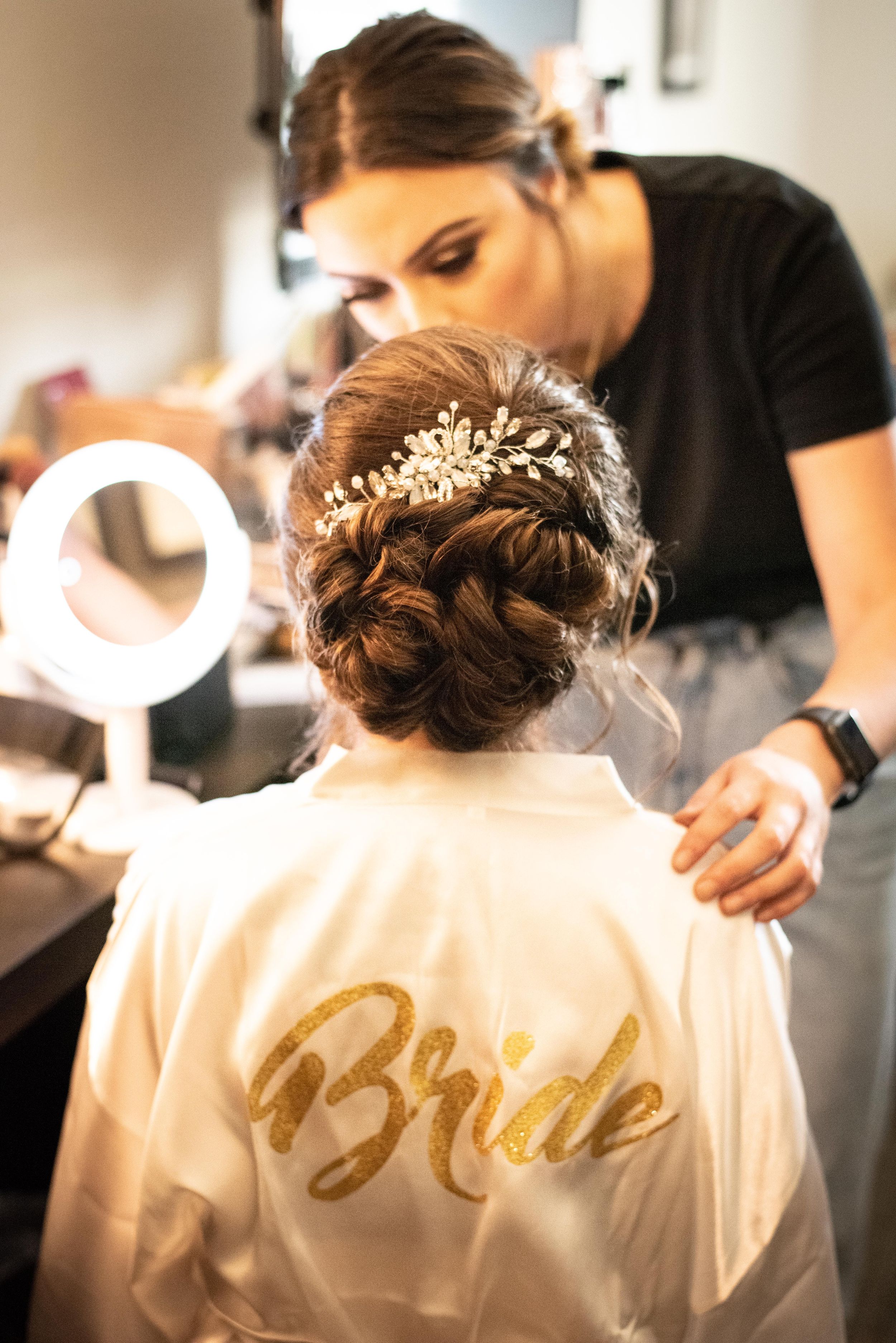 bride getting ready for wedding in robe