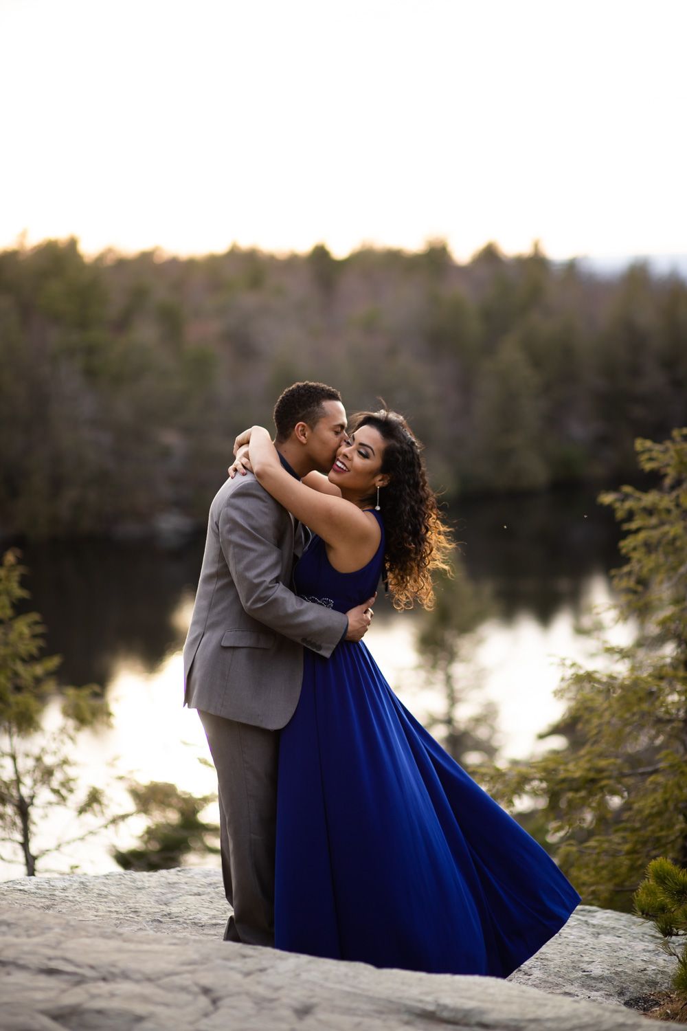 Adventure engagement photo session on a cliff at Minnewasksa State Park