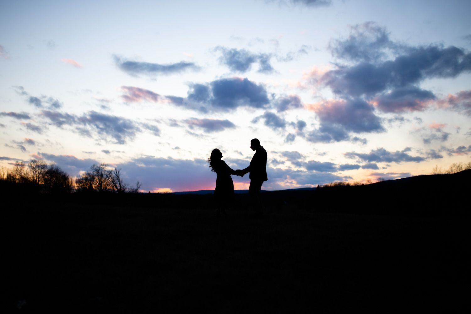 Engaged couple silhouetted by the sunset in the Hudson Valley