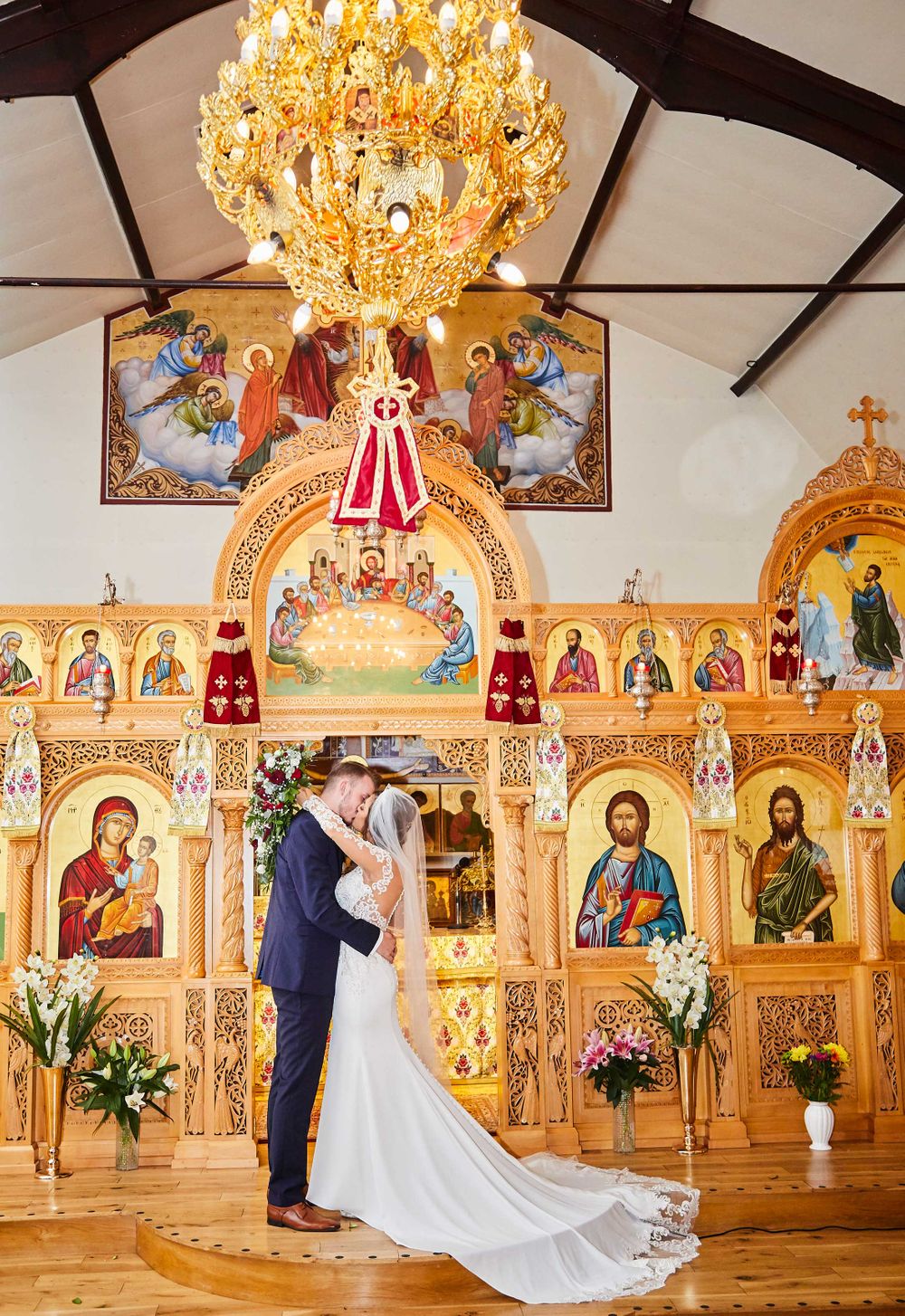 Bride and groom kissing in greek church