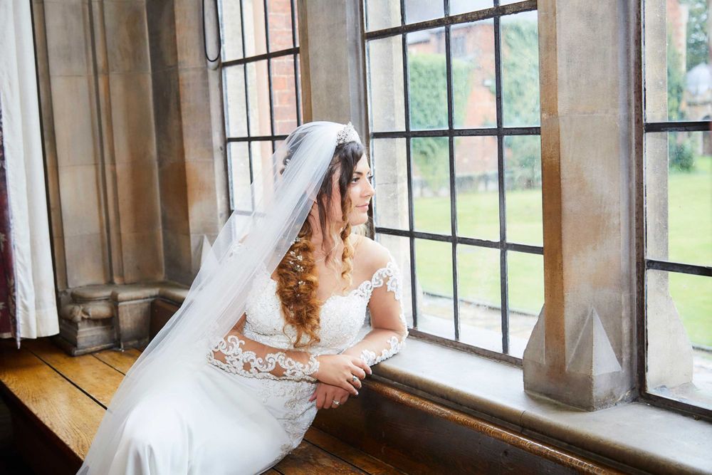 Greek bride looking our of window