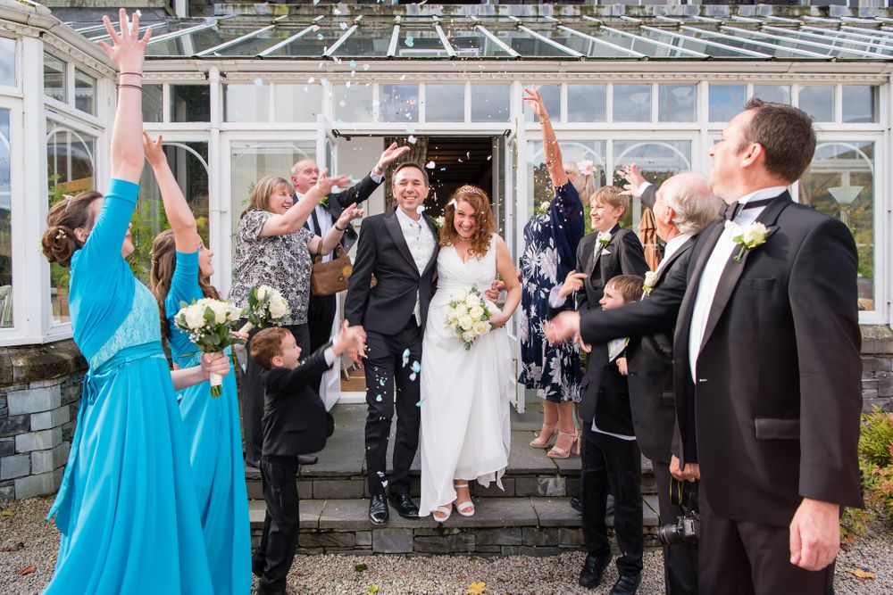 Couple exit after ceremony at Lakeside Hotel beside Windermere