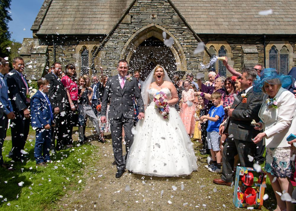Confetti shower for bride and groom after Church wedding