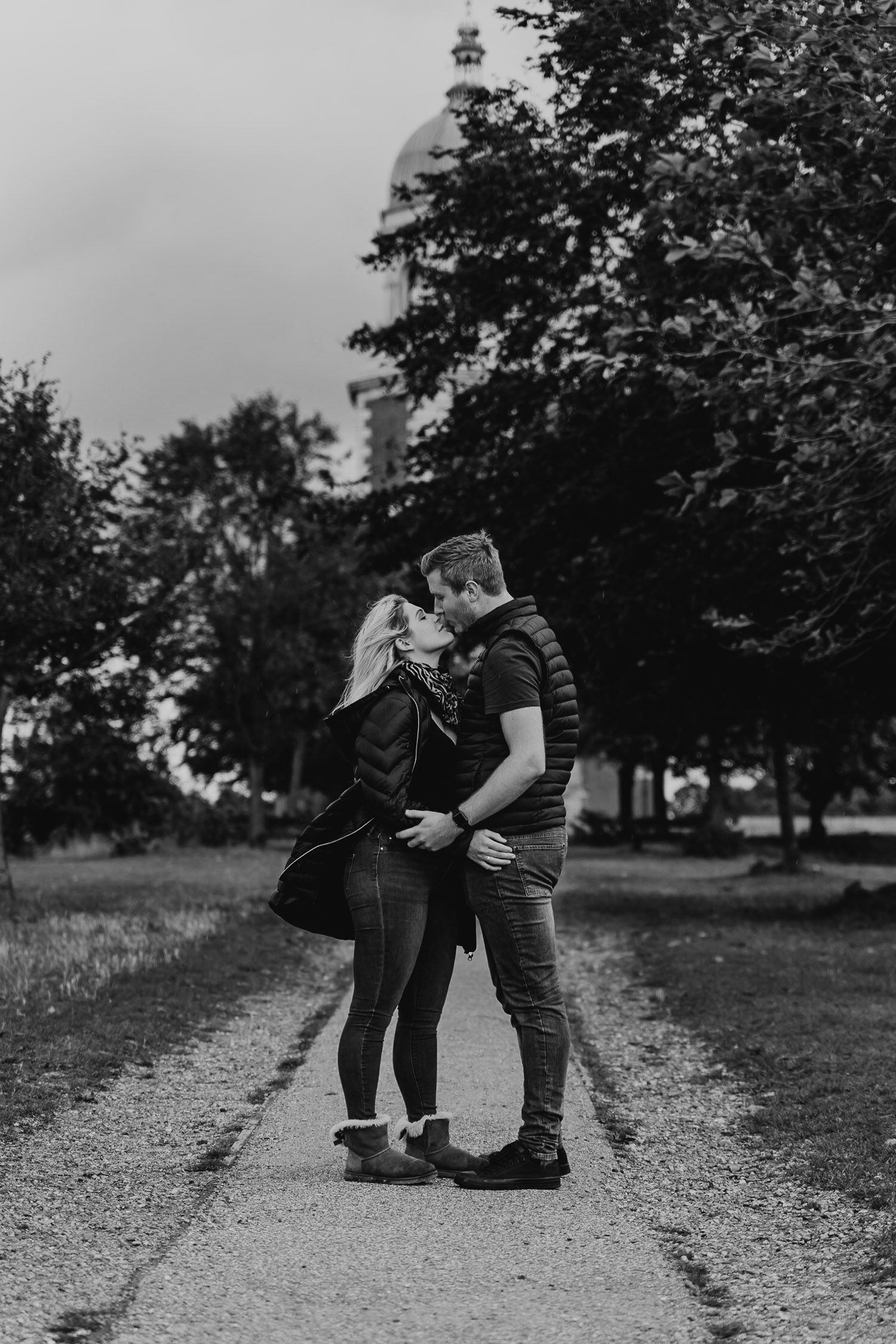 Black and white photo of a couple kissing in front of Netley Chapel. Katherine and her Camera engagement photoshoot.
