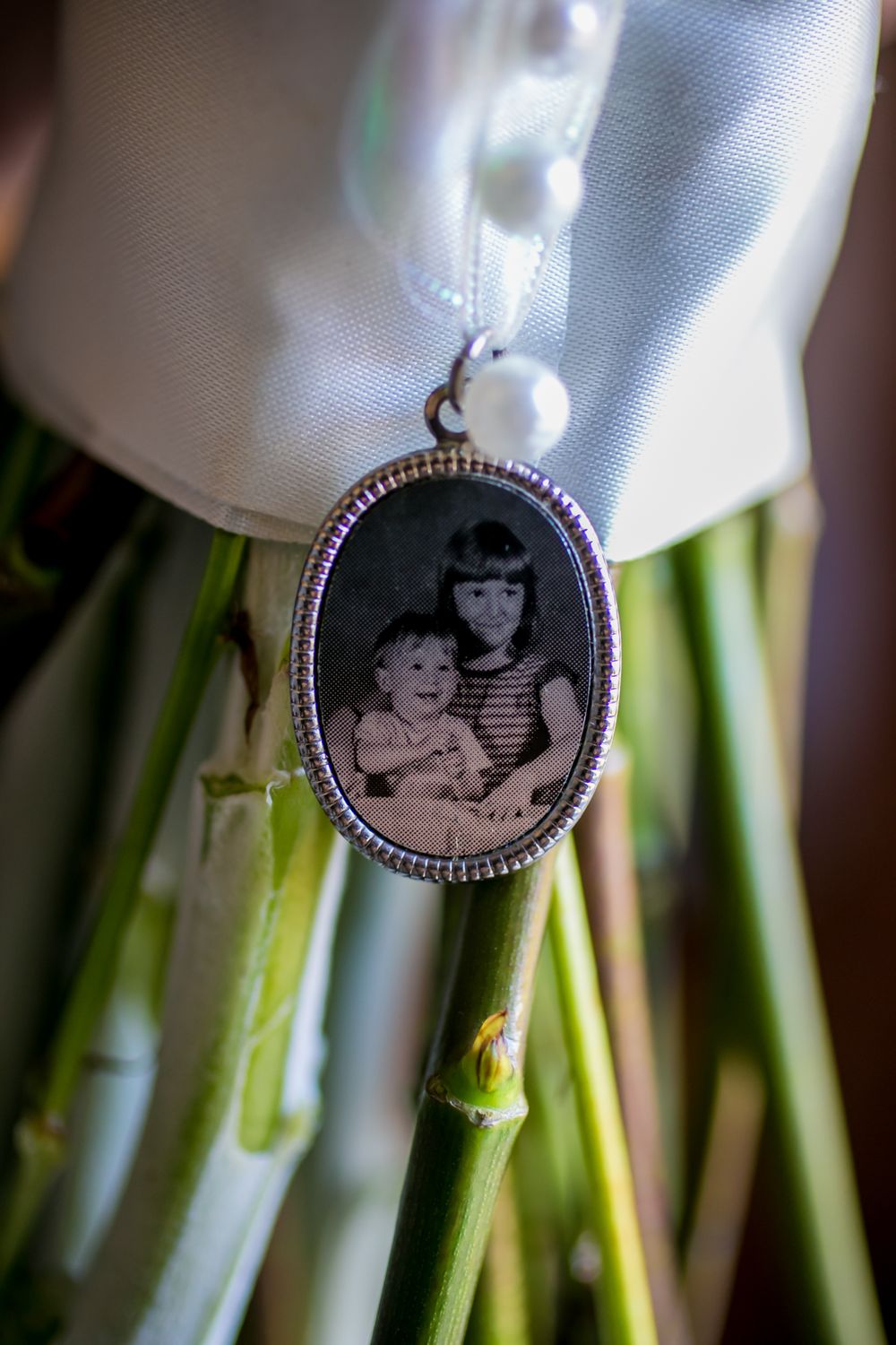 Locket on a bouquet the wedding of Miranda & Marcus Lattimore at the Lace House in Columbia, SC. Photo by Jeff Blake