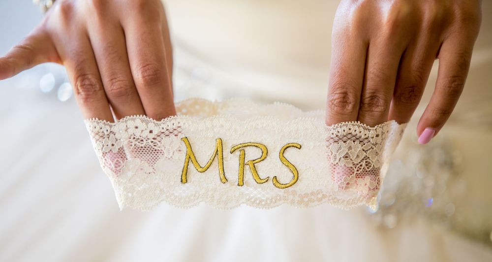 the wedding of Miranda holds her garter before her wedding at the Lace House in Columbia, SC. Photo by Jeff Blake