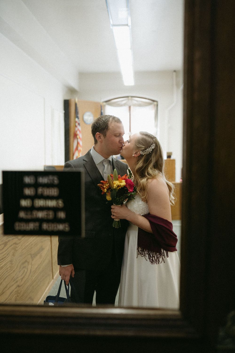 bride-groom-first-kiss-elopement-polk-county-courthouse-desmoines-iowa-raelyn-ramey-photography