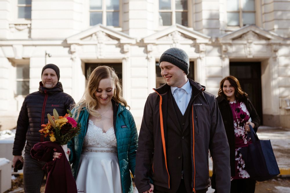 bride-groom-walk-out-of-court-house-elopement-polk-county-courthouse-desmoines-iowa-raelyn-ramey-photography
