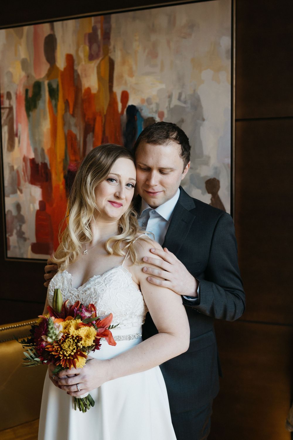 bride-groom-posing-in-front-of-painting-the-republic-on-grand-elopement-desmoines-iowa-raelyn-ramey-photography