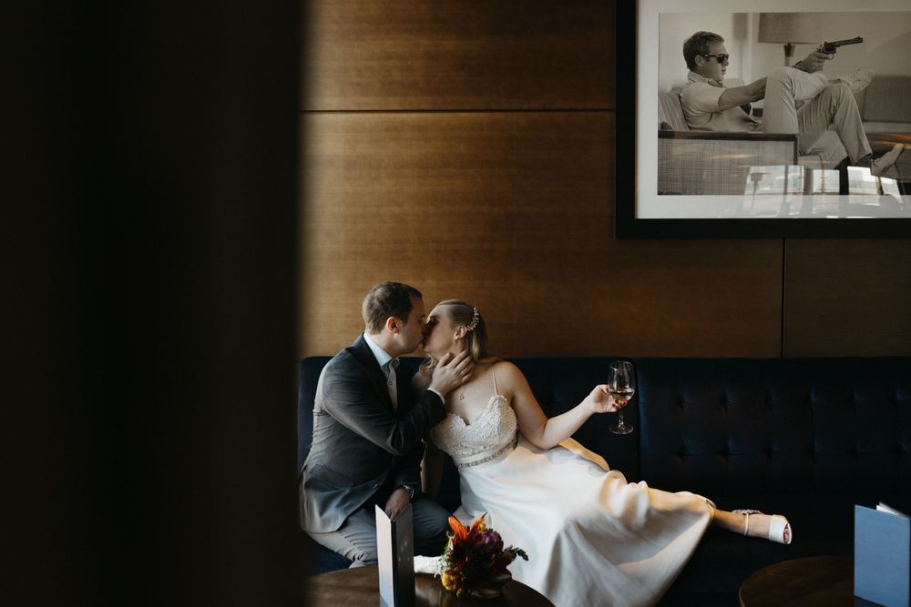 bride-groom-kissing-at-the-republic-on-grand-elopement-desmoines-iowa-raelyn-ramey-photography
