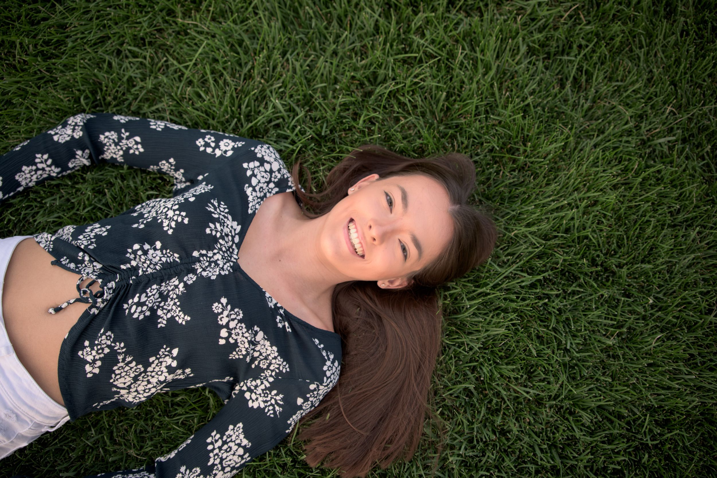 Malina (St Jospeh Academy Class of 2020) in grass in front of Fountain of Eternal Life, Cleveland, Ohio