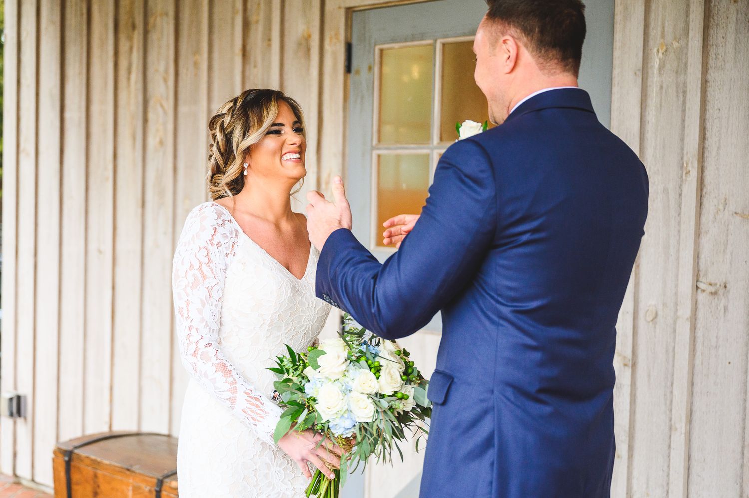 bride and groom laughing during the first look