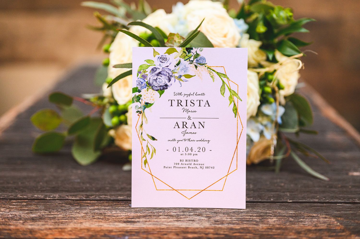 invite details on wooden plank